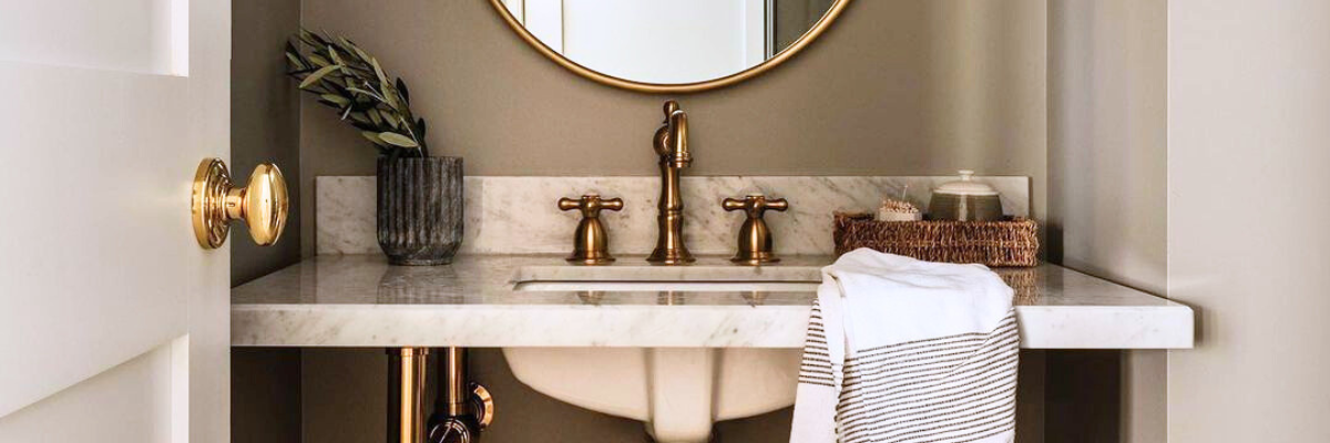 console sink with brushed brass bathroom faucet